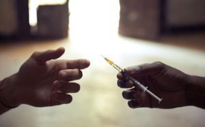 heroin needle being passed